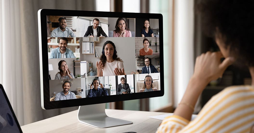 A group of people on a computer screen during a video conference call.